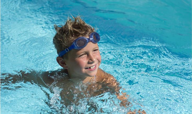 A child is swimming in a pool